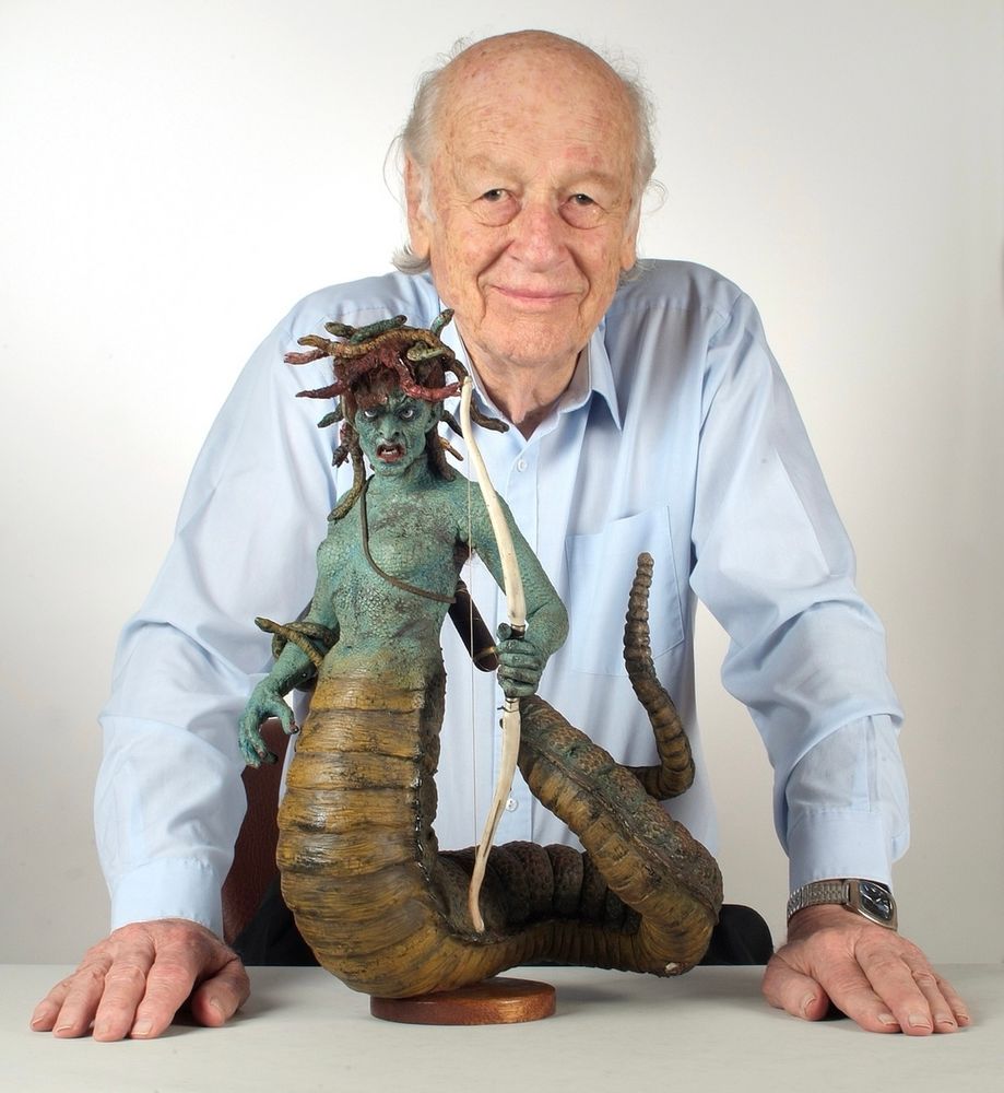 Stop motion special effects artist RAY HARRYHAUSEN posing with a statue of Medusa that he created for the film CLASH OF THE TITANS. 