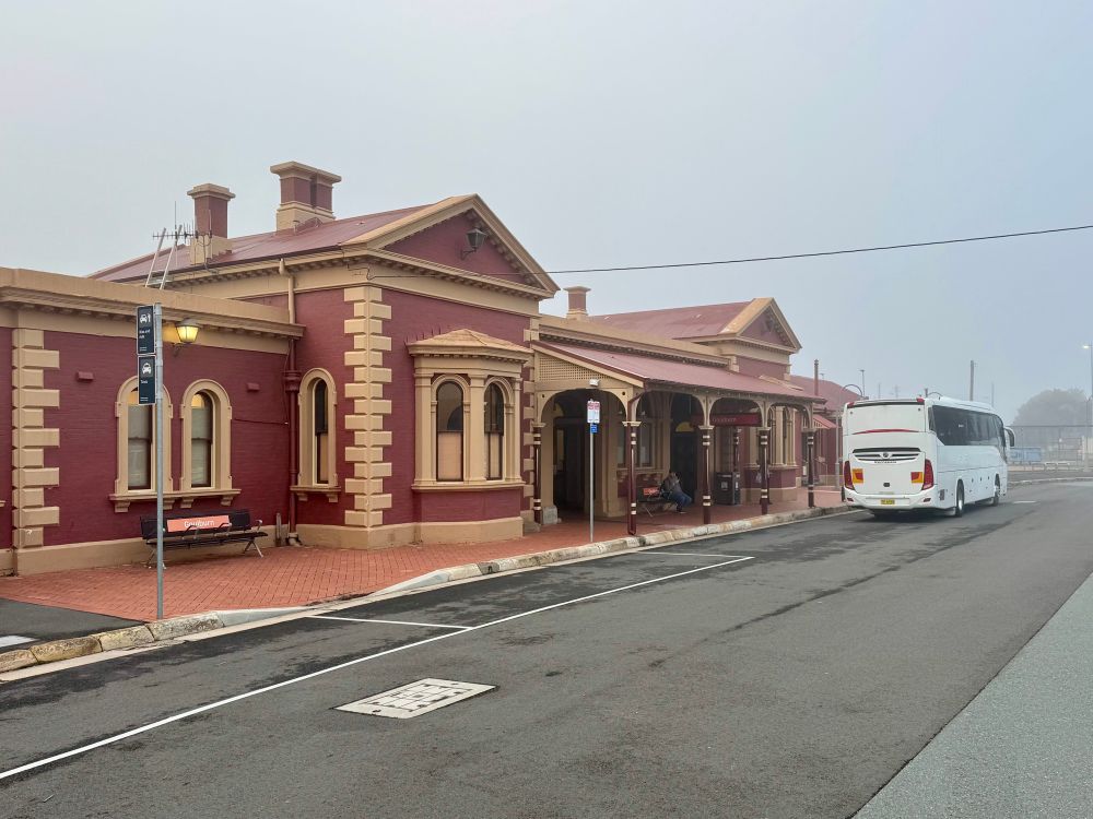 A coach bus in front of Goulburn train station 