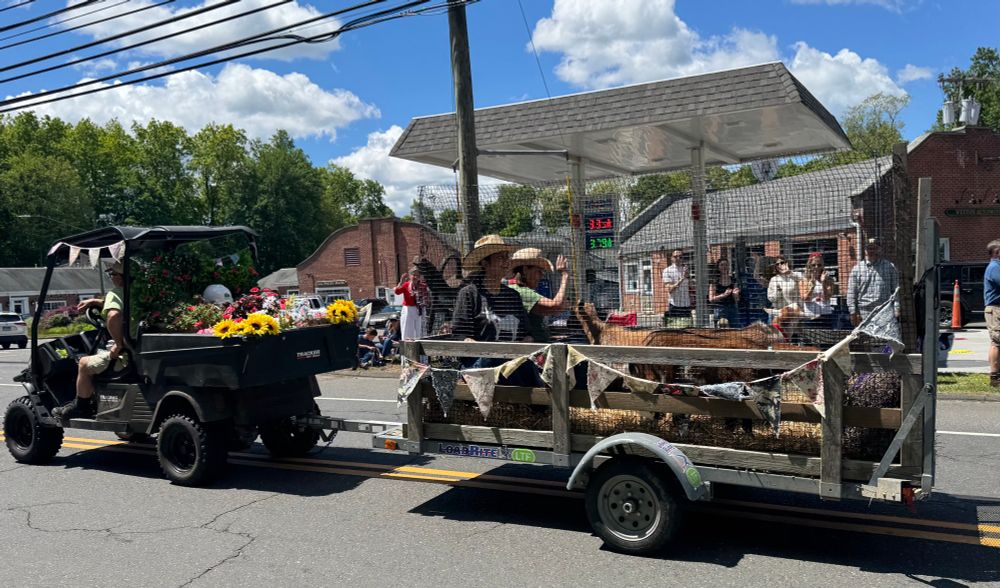 A parade float with a pair of goats on it.