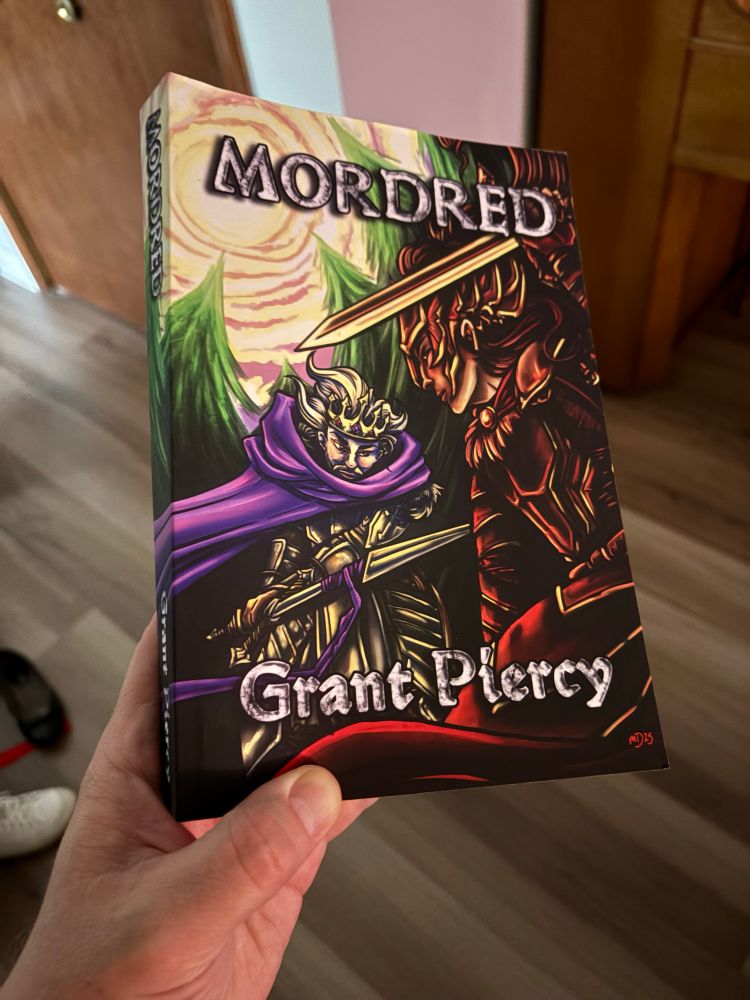 a physical copy of MORDRED by Grant Piercy, cover art by Sanrixian featuring by a clash between Sir Mordred and King Arthur