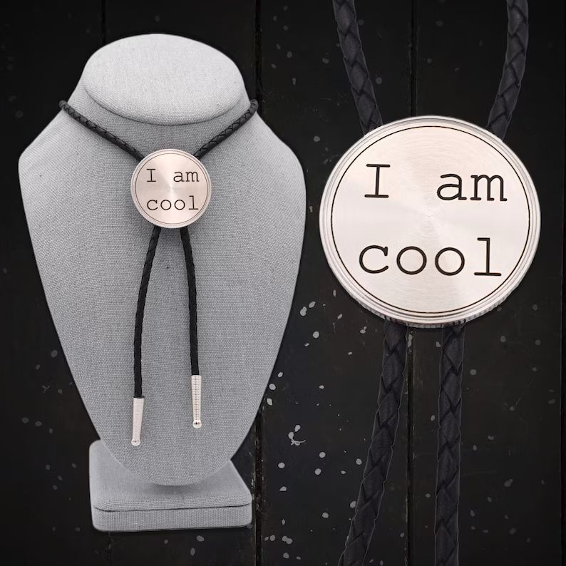 A plain silver bolo tie that says "I am cool" in a boring font. It does not look cool.
