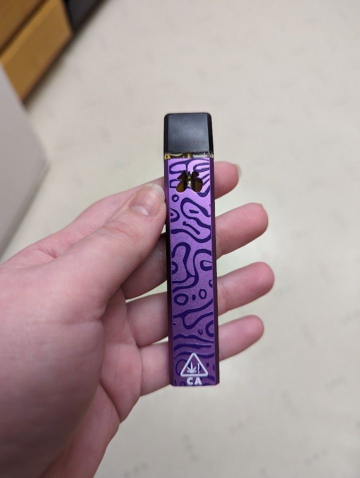 purple disposable vape with a funky pattern