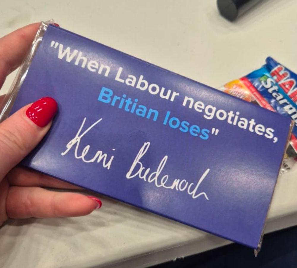 A bar of chocolate with Kemi Badenoch's signature on it and the words 'When Labour negotiates, Britian loses' (i.e. Britain is misspelled).