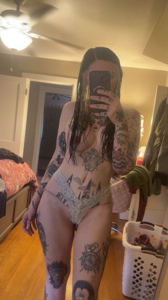 Woman wearing blue lacy underwear with hair covering the nipples to show postop breast augmentation and tummy tuck surgery results 