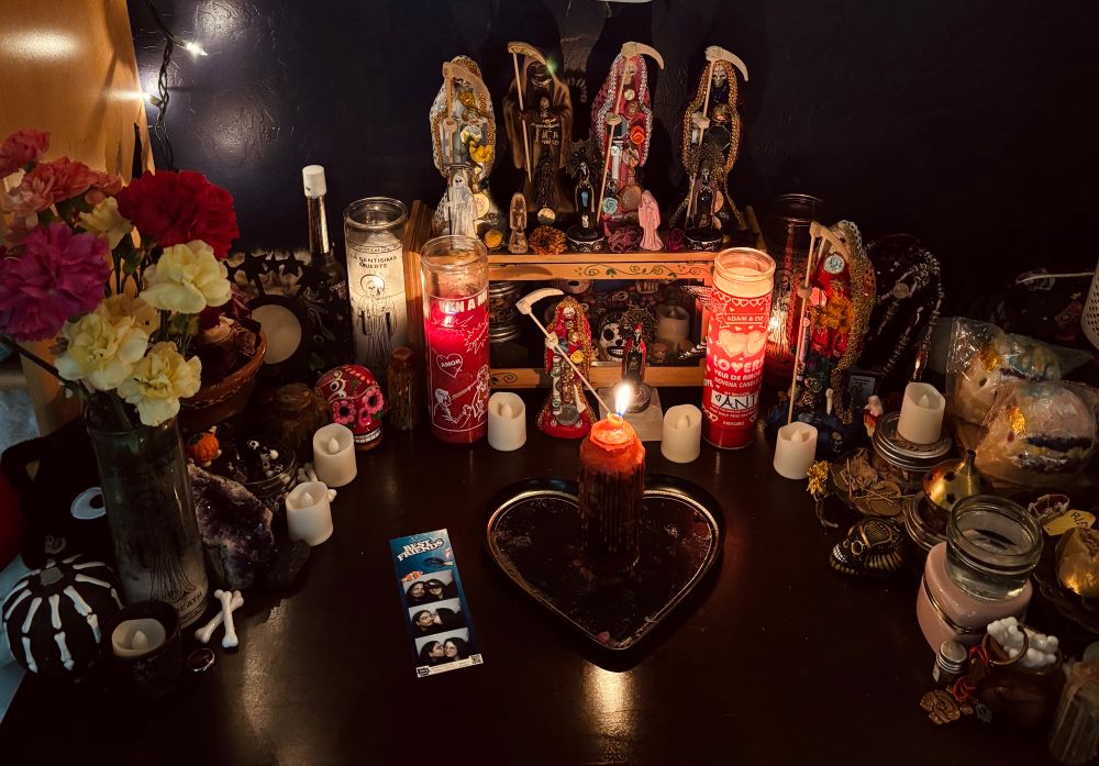 red candles alit santisima's altar with a spell jar 