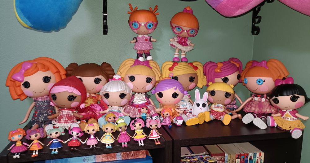 Collection of Lalaloopsy dolls on top of two bookcases