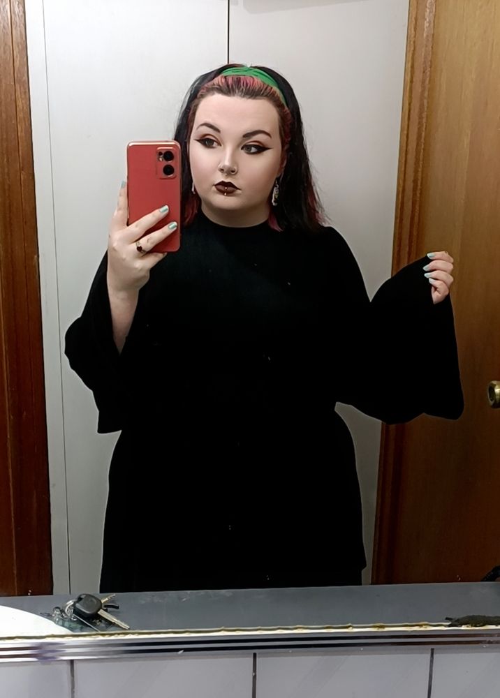 Mirror selfie of Chilli looking slightly more snatched than usual in a black bell-sleeve tunic dress 