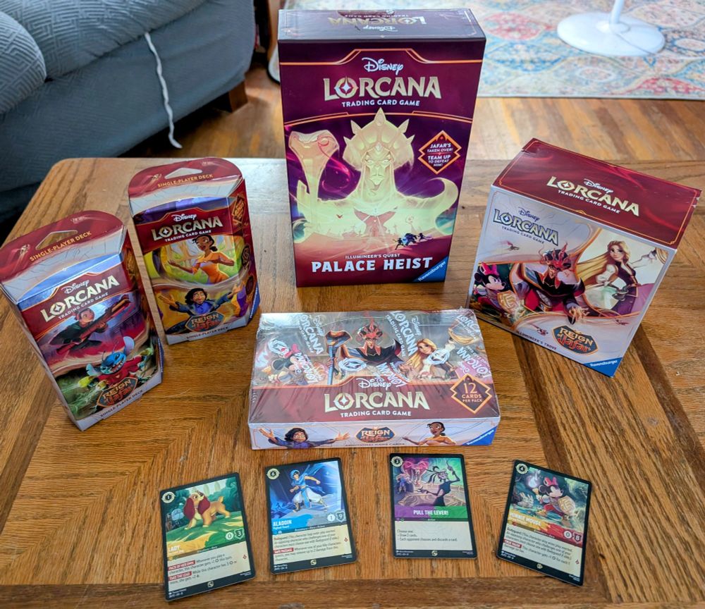 Lorcana Reign of Jafar series, 2 starter decks, an illumineers tribe box, a booster box, the palace heist expansion and 4 dual ink promo cards.