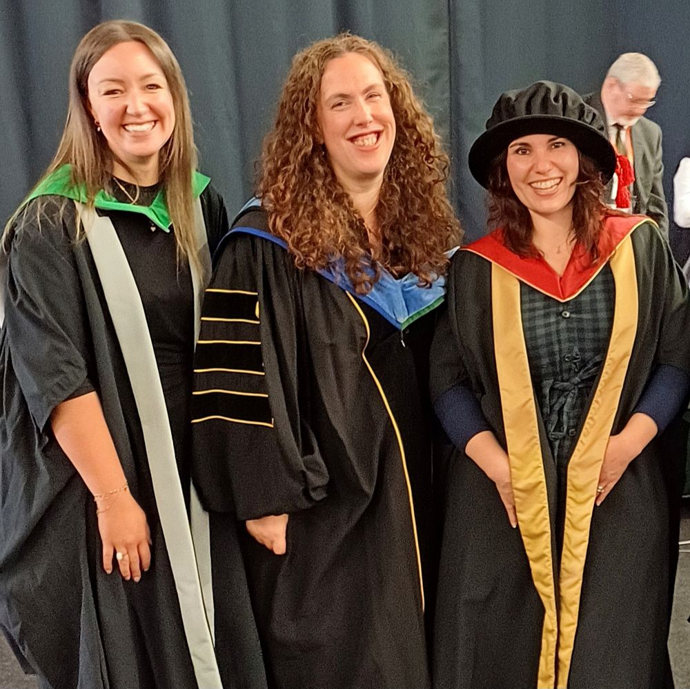 Photo of criminologists Dr Ashley Rogers, Dr Hannah Graham, and Dr Diana Miranda in graduation gowns and smiling.