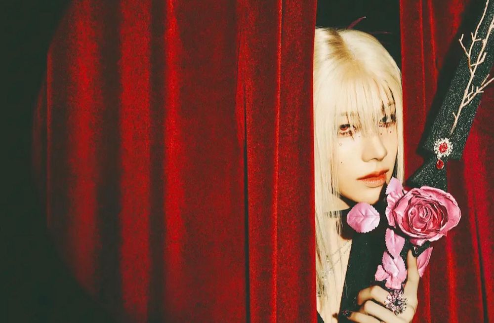 Rui looking absolutely stunning in the promo for their upcoming mini album. He’s styled in black and pink, long blond hair with bangs and a flowery sword