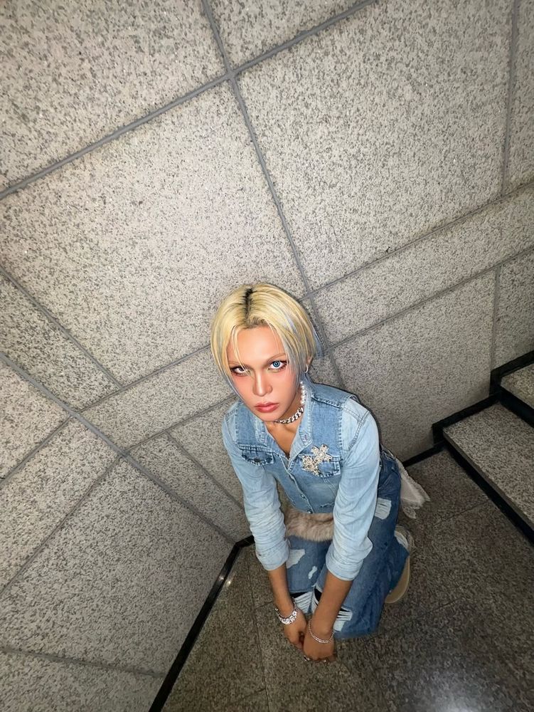 Hyun in all denim, icy blue streaks in his blond hair