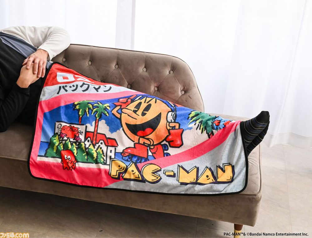 A man has a snooze under his FC Pacman box blanket