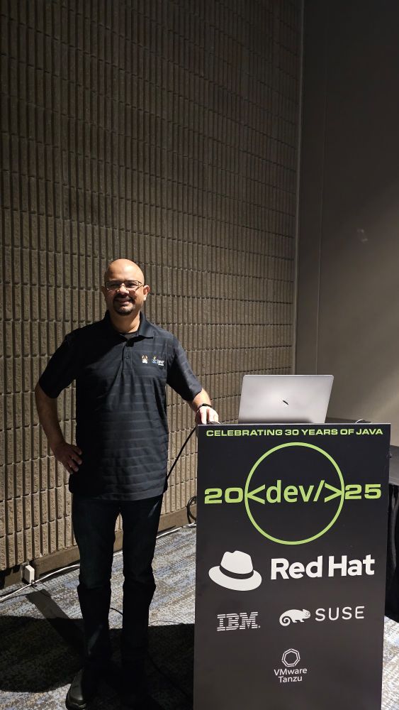 Me at a podium before one of my talks at Devnexus 2025.