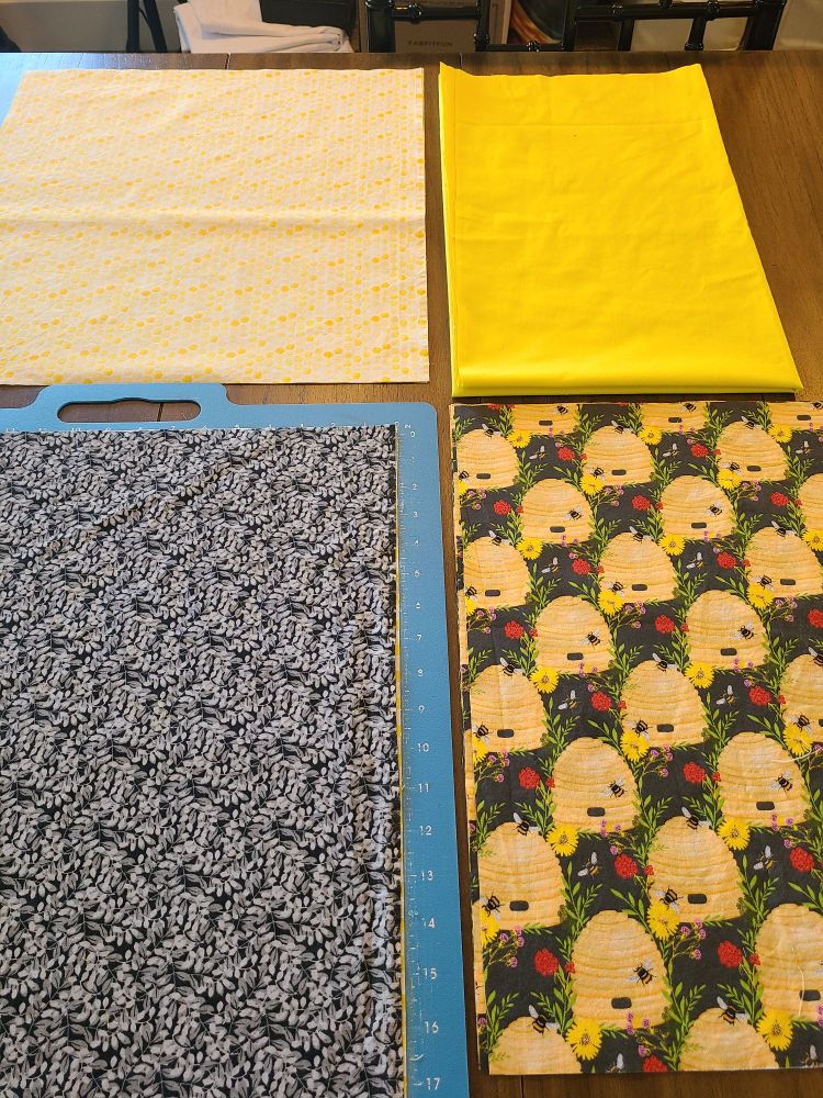 Yellow and black fabric are lined up waiting to be cut for a skirt sewing project.