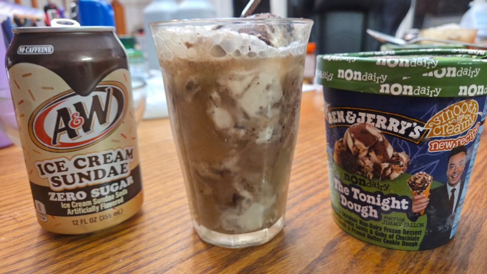 left: a can of A&W "ice cream sundae" zero sugar soda.
right: Ben & Jerry's "The Tonight Dough with Jimmy Fallon" caramel and cookie dough non-dairy ice cream
middle: a glass with the ice cream scooped in and the soda poured on top to make an ice cream-flavored ice cream soda float