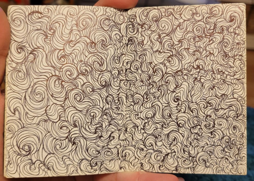 The curls and squiggles on these pages are more directional, starting bottom right and radiating outwards and upwards, the left page has larger ones.