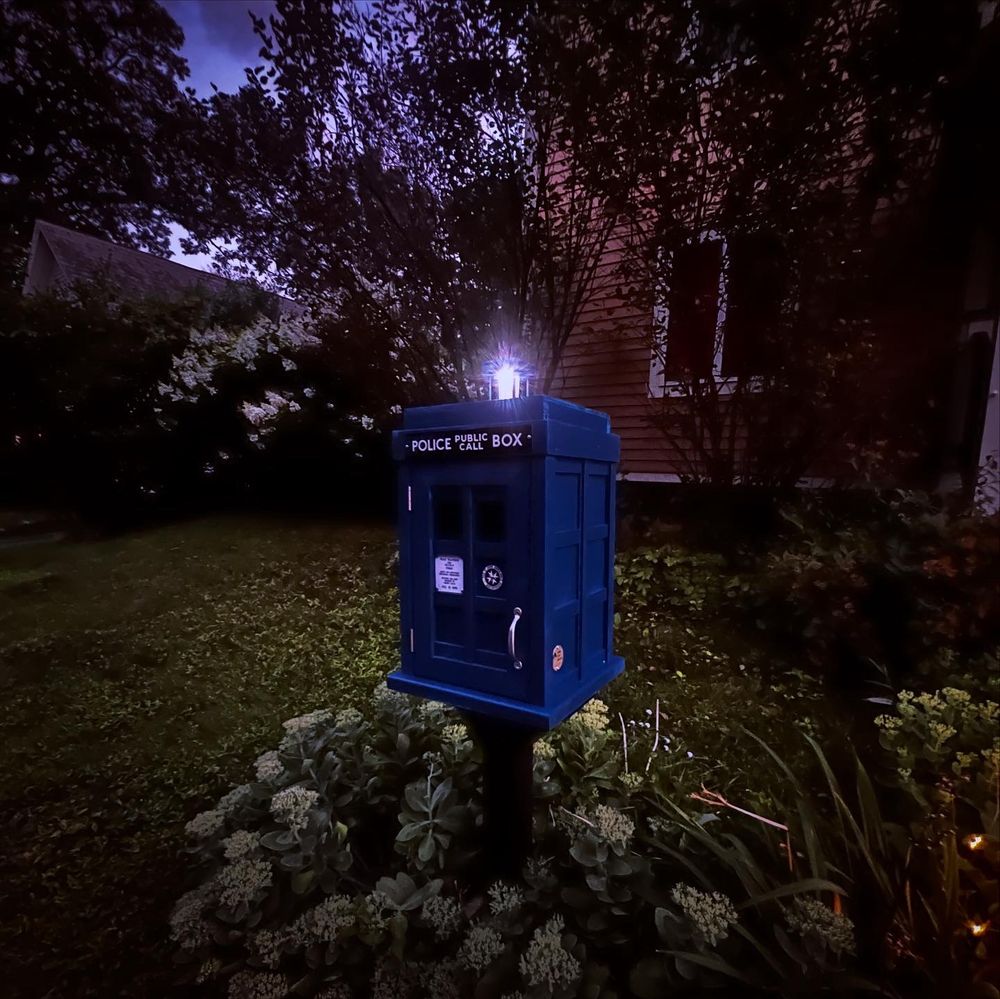 TARDIS little free library at dusk with light 