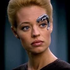 Seven of Nine showing her teensy bit of external cybernetics around her eye.