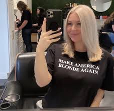 Some horrible blonde “pick me” girl taking a selfie in her black t-shirt with white print that says “Make America Blonde Again” 🤦‍♀️