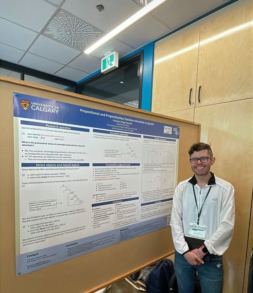 A student standing beside his conference poster titled "Prepositional and prepositionless durative adverbials in Spanish".