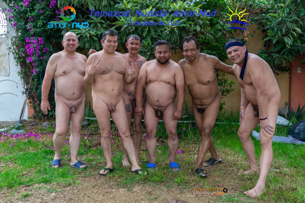 Six nude men on a lawn, in various poses.  The picture has the Amor-Nud logo, the Naturist Symbol, and the legends "Amor-Nud Nudist Temazcal" and "June 15, 2025".