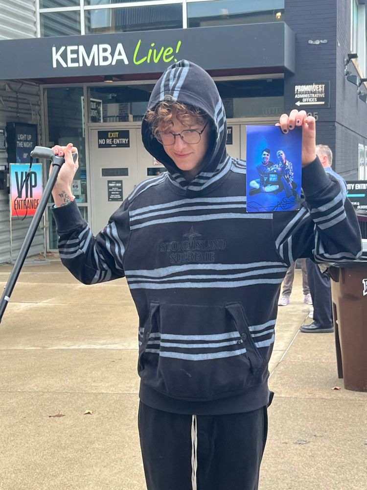 isaac holding a picture if dan and phil