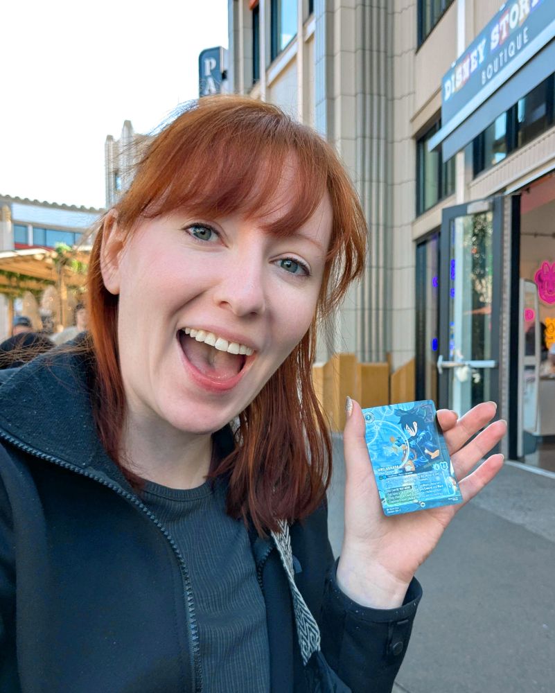 Ellie holding an Enchanted altered art of Hiro Hamada - Armor Designer from Disney Lorcana. 