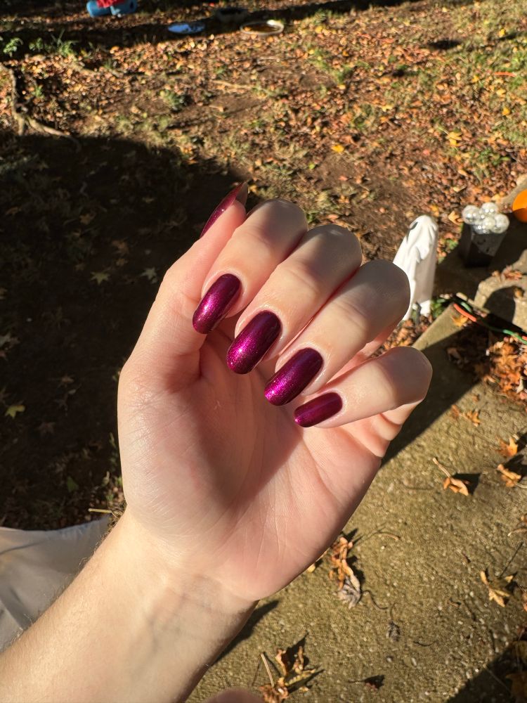 a picture of AJ’s nails in a plum sparkly color