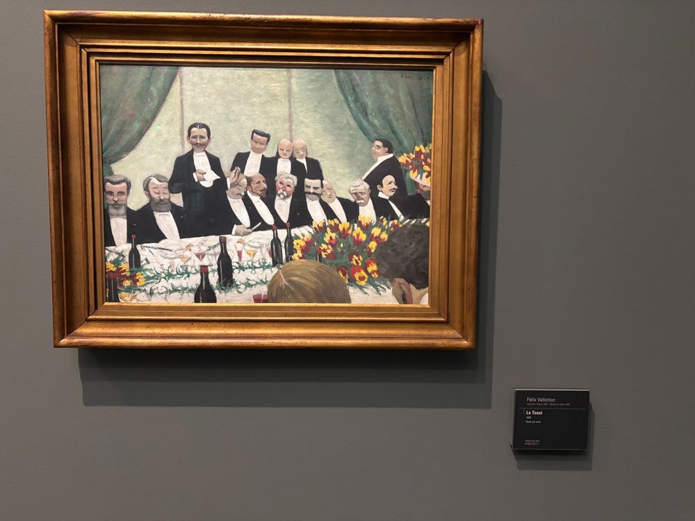 A photograph of the painting "Le Toast' by Félix Vallotton as displayed in the Musée D'Orsay in Paris, France.