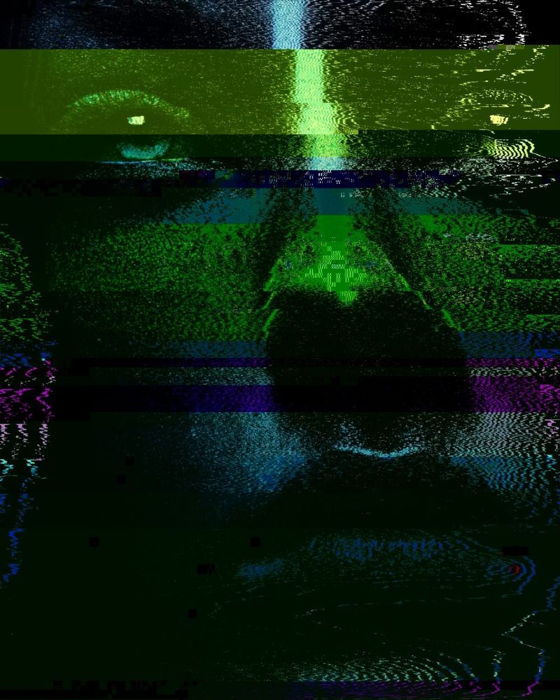 A portrait of a person's face. It is shifted and corrupted with glitch art style elements and signal modulation.

