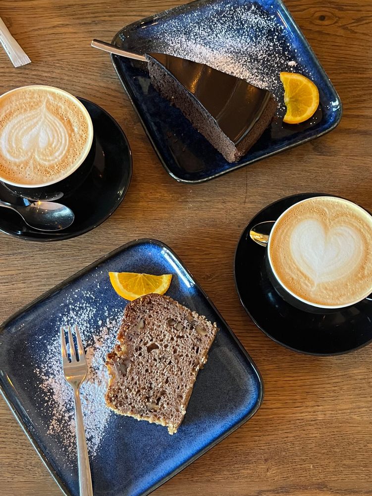 Two sets of coffee and cake