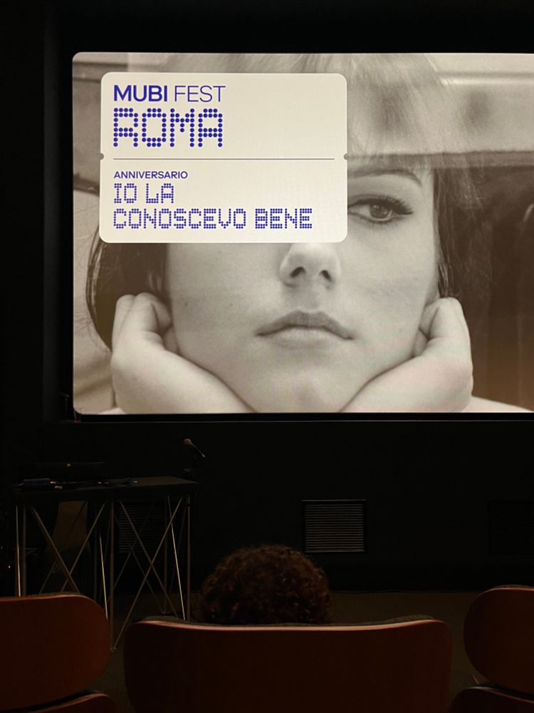 MUBI FEST ROMA —
Anniversario IO LA CONOSCEVO BENE
written on a cinema screen with a still from the film as the background 