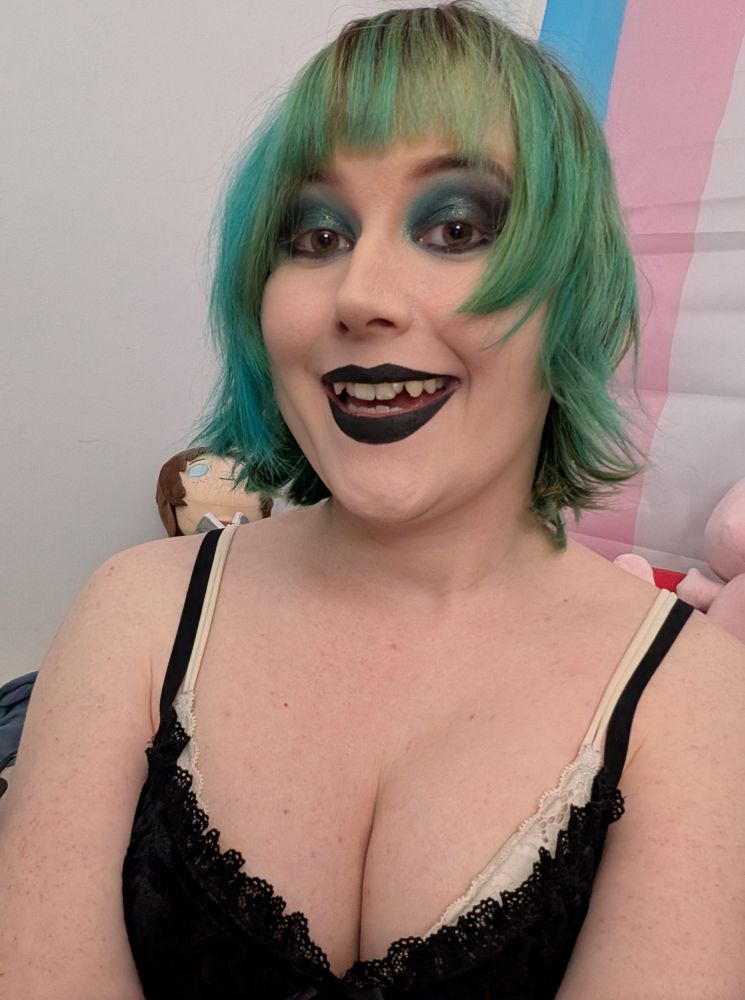 Revy wearing blue green black eyeshadow and black lipstick 

She's showing her small fangs