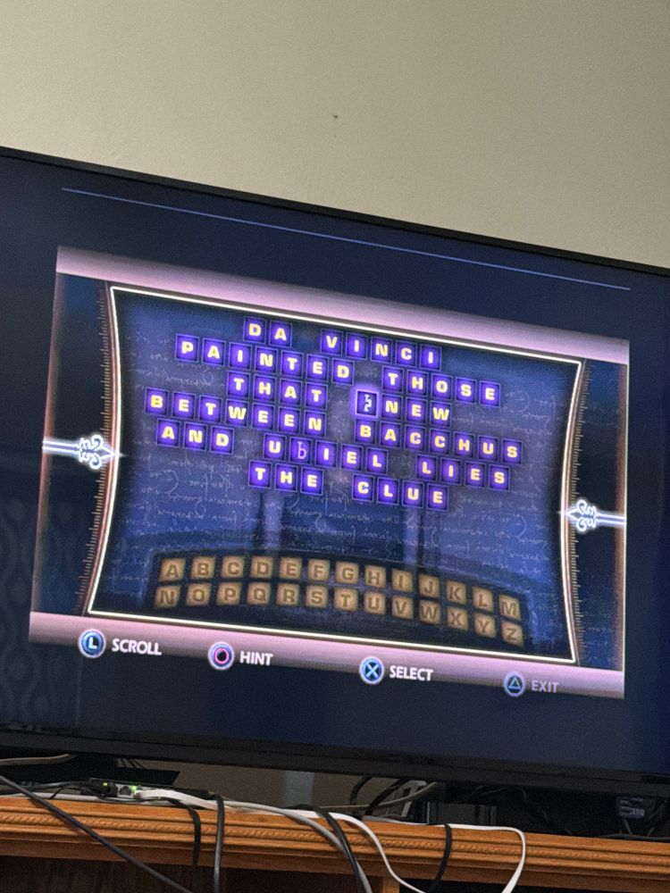 Photo of a TV screen showing a substitution cipher from the Da Vinci Code game for PS2