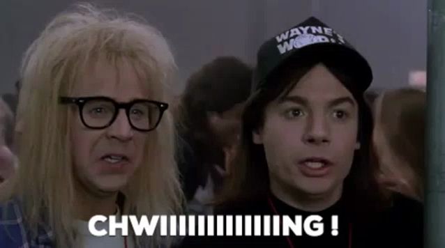 a man wearing a hat that says wayne 's world is standing next to another man