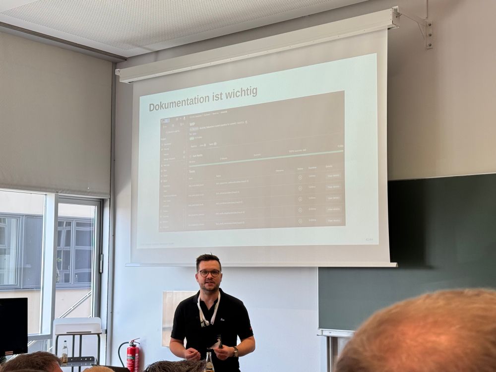 Christian Stankowic sharing his automation expertise, slide with GitLab test reports. 