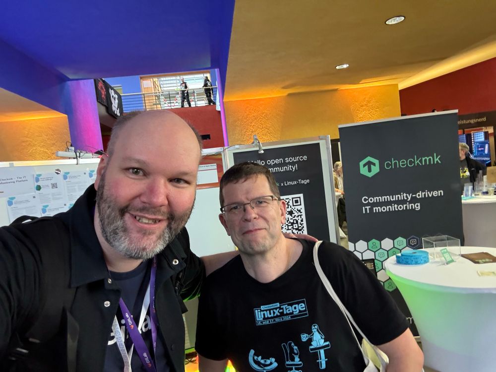 Michael & Christian in front of the CheckMK booth, sharing monitoring community stories since 2009. 
