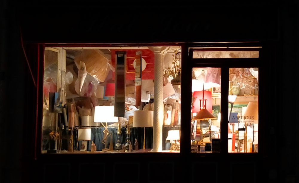 A lighten lampshades shop in the dark.