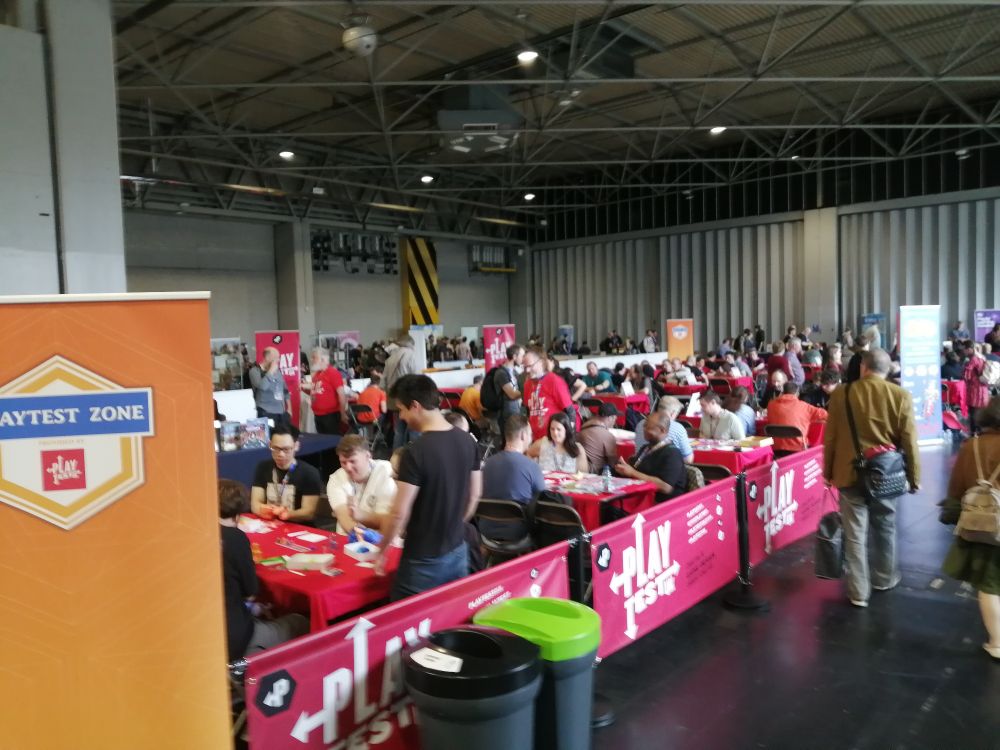 Lots of people playing games in a big hall