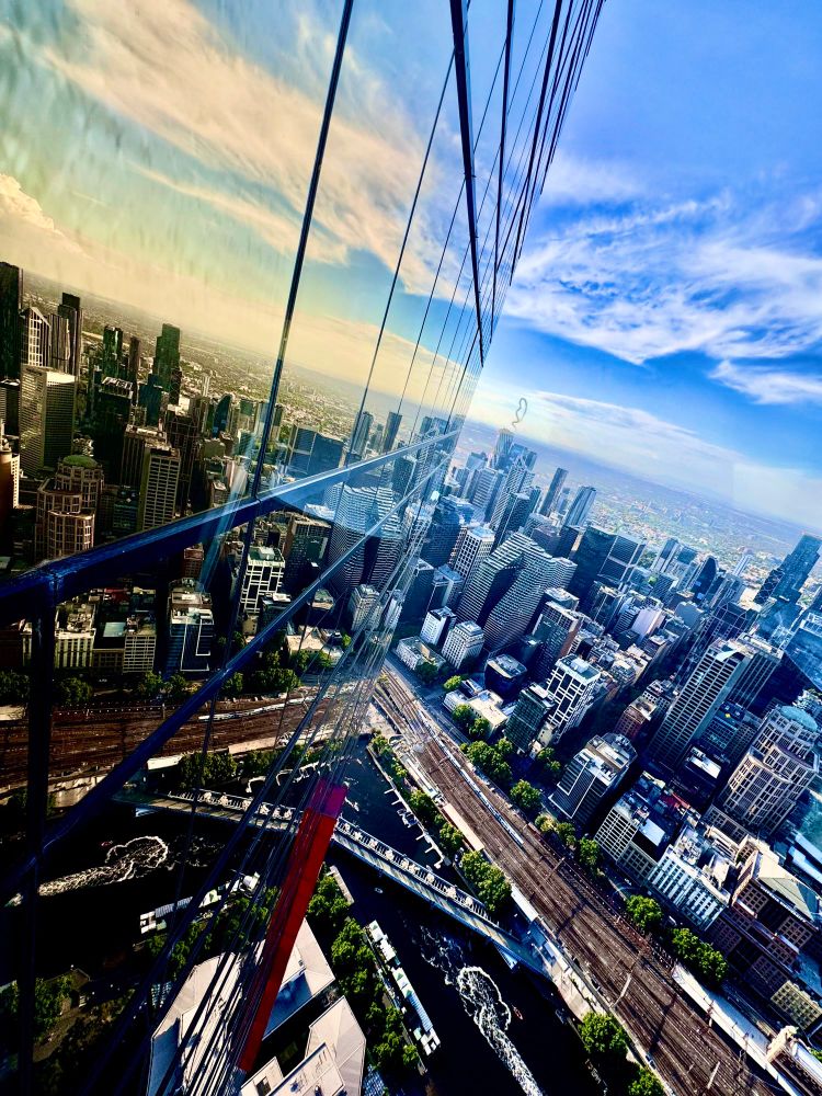 The Melbourne skyline as seen from the 88th floor of the building. Multiple buildings are seen from across the river. 
