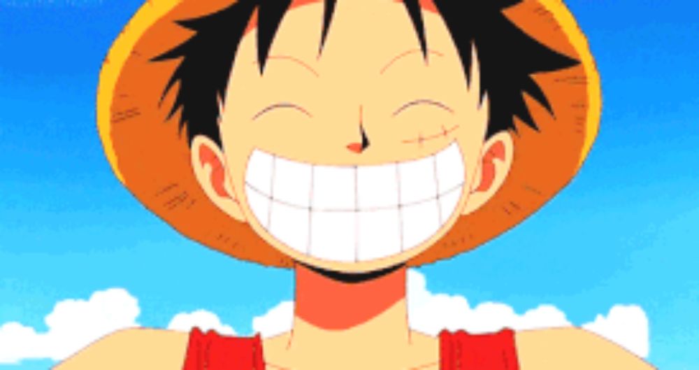 luffy from one piece is smiling and wearing a hat