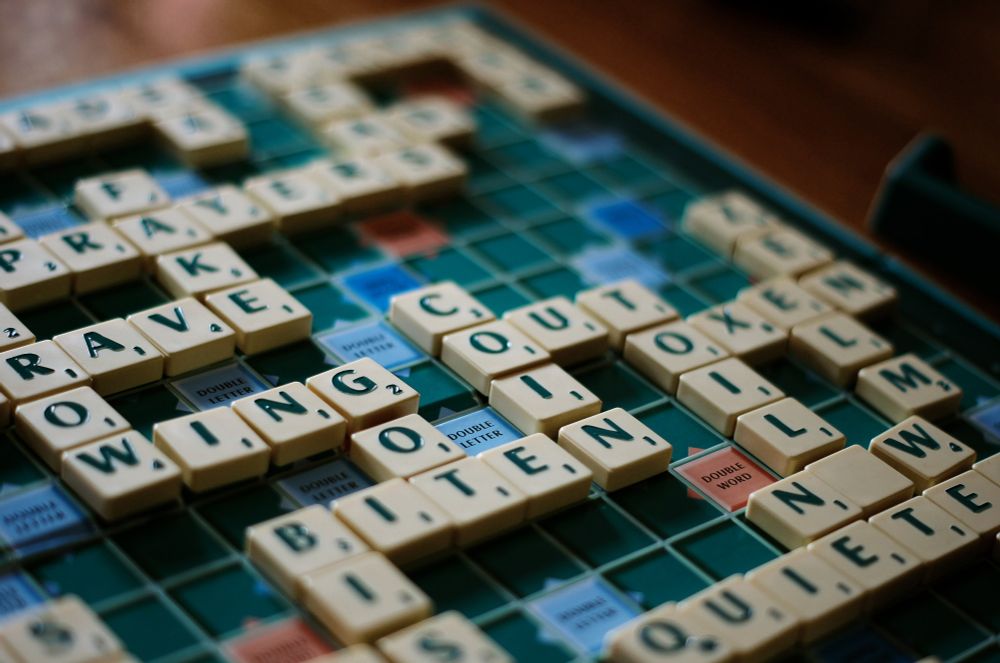Photo shows a close up of a Scrabble game
