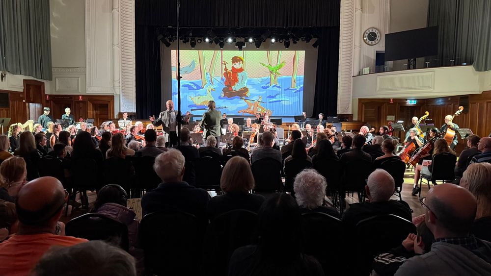 A photograph taken from the third row of the ground floor of the Williamstown Town Hall showing an illustration of the characters on Prokofiev’s Peter and the Wolf and their corresponding orchestral instruments. 