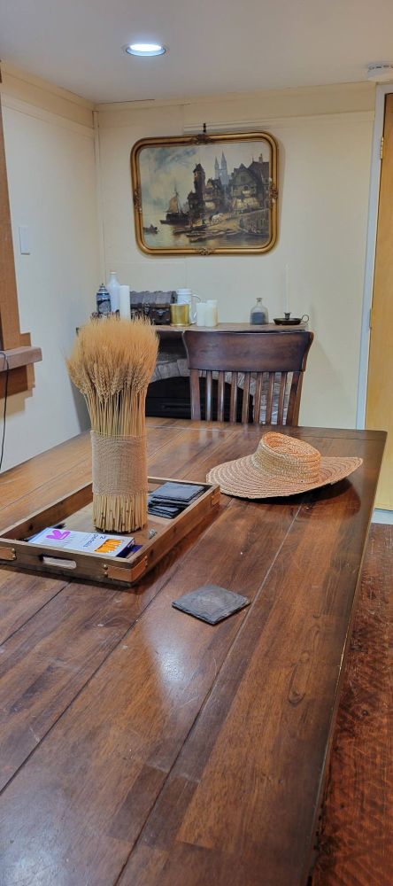 The gaming table before the players descend on it with a sheaf of wheat and a farmer's hat on display. 