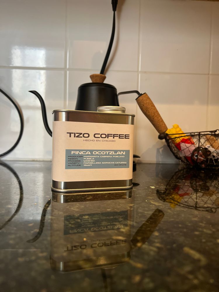 A can that looks like an old oil can but it is filled with coffee beans. 