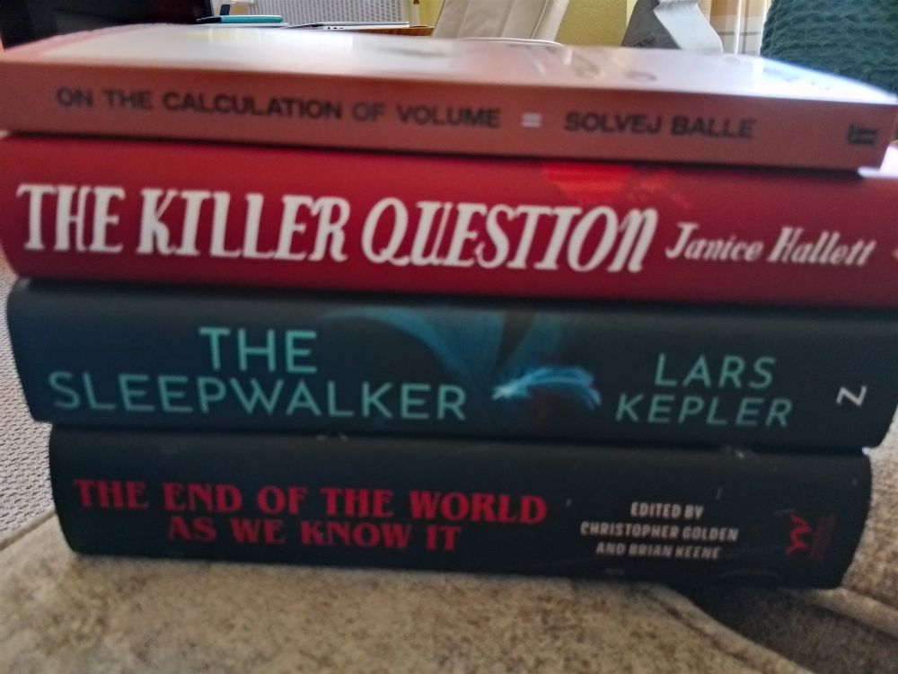 Stack of 4 books: 
On the calculation of volume 2
The killer question
The sleepwalker 
The end of the world as we know it