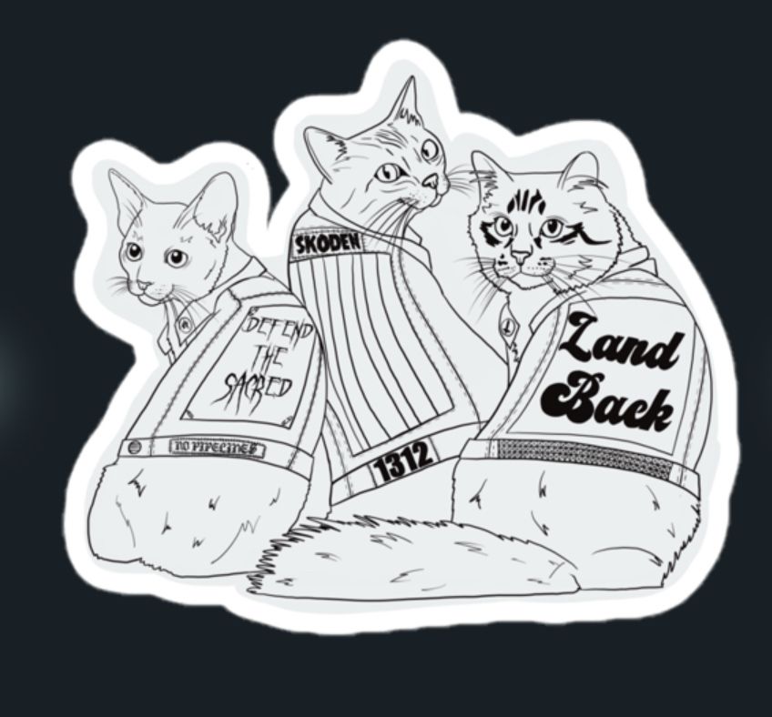 sticker with cats wearing vests that say land back and skoden and defend the sacred 