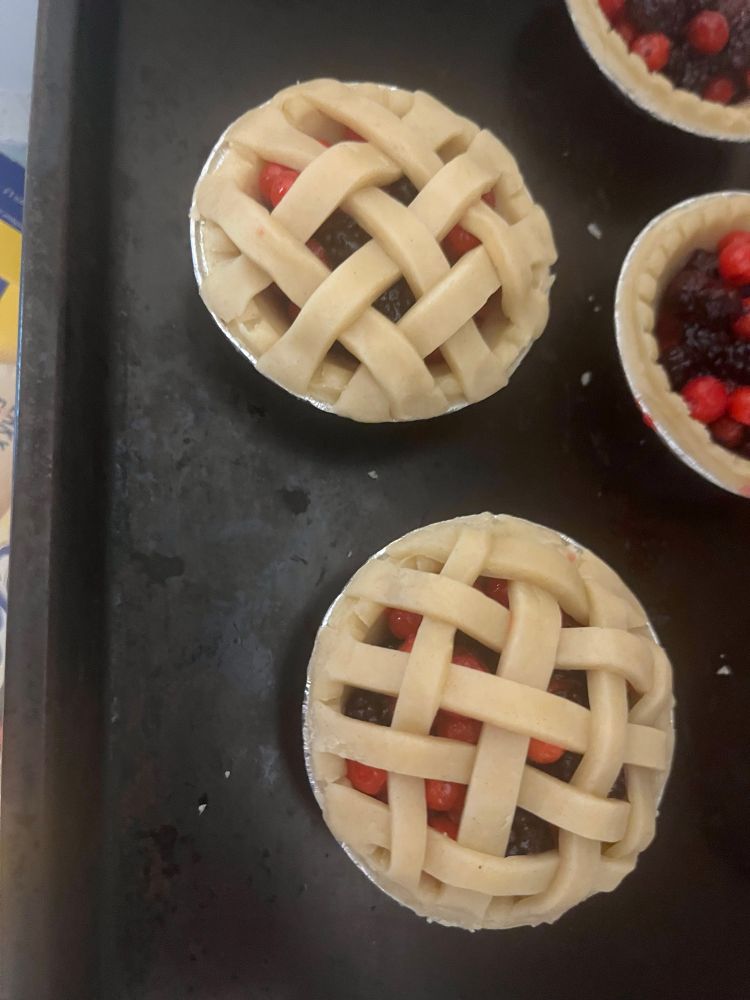 handmade tarts out of the berries from the previous images made with lattice tops. photo before they went in the oven. 