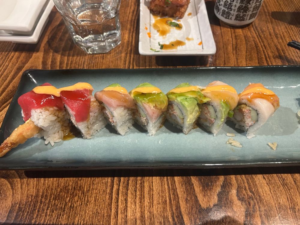 “New Rainbow Roll”. 
In: Tempura shrimp, imitation crab, cucumber, seaweed.
Top: Assorted fish (including tuna and yellowtail)