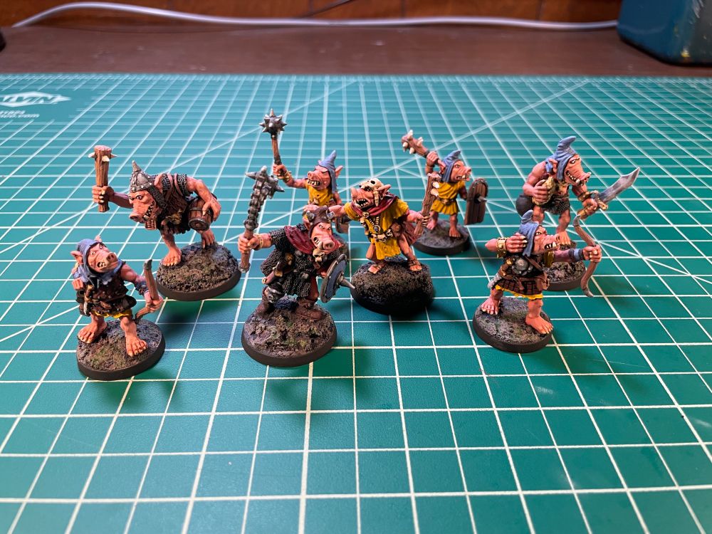 Eight 28mm gaming miniatures. Pig faced orcs sculpted by Kev Adams from Otherworld Miniatures and Dragon Bait Miniatures.